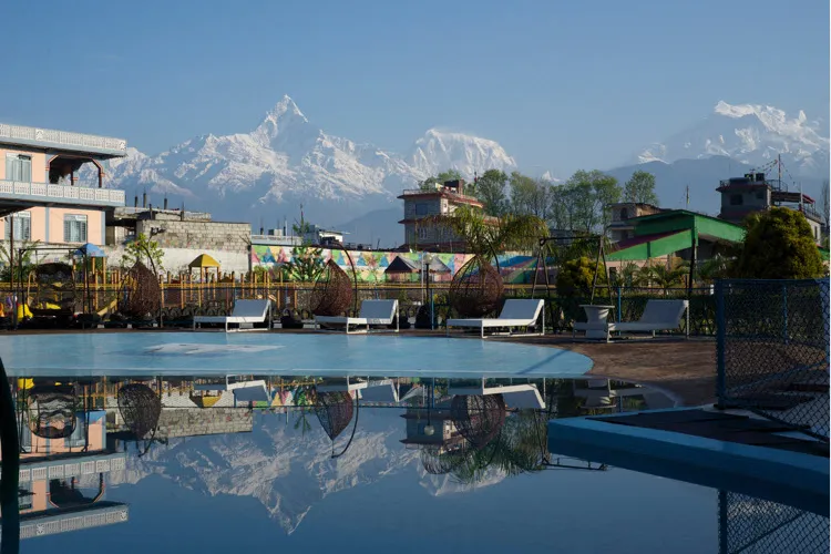 The pool and gardens at Hotel Jal Mahal, with the Annapurna range reflected in the water